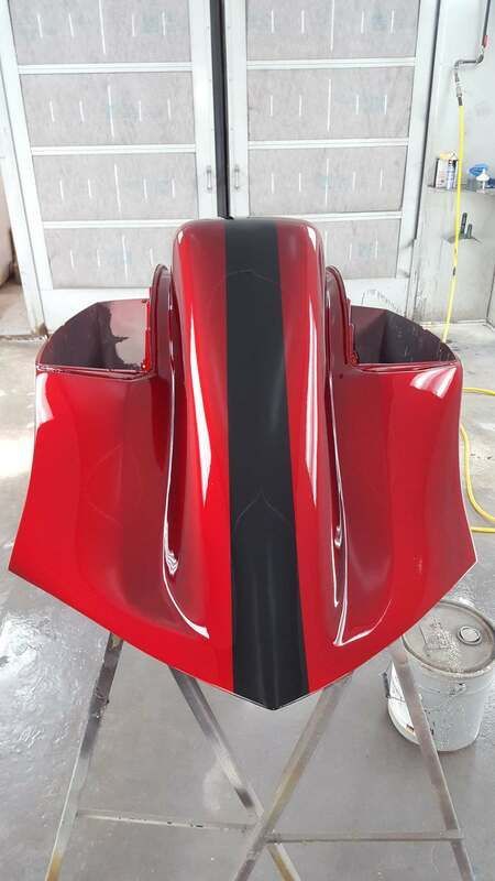 A red and black motorcycle is sitting on a stand