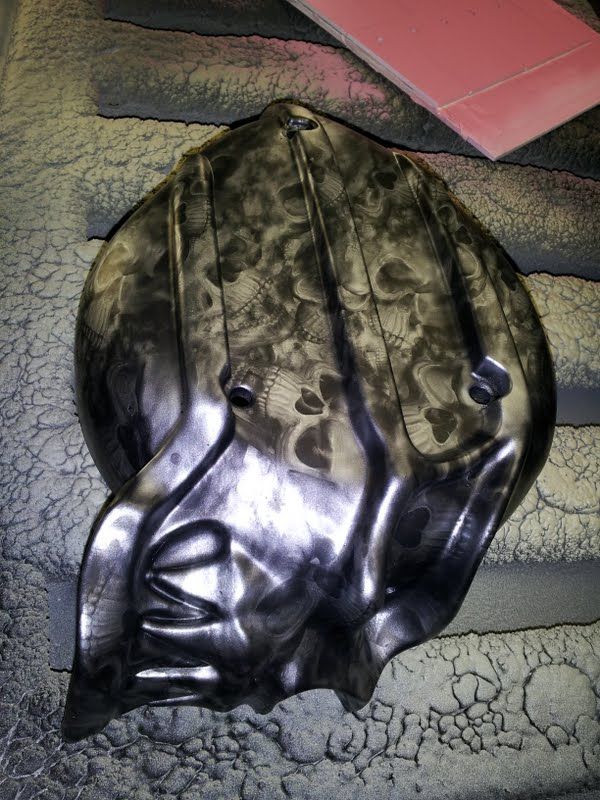 A black object with skulls painted on it is sitting on a table.