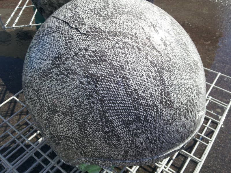 A large gray ball is sitting on a wire rack