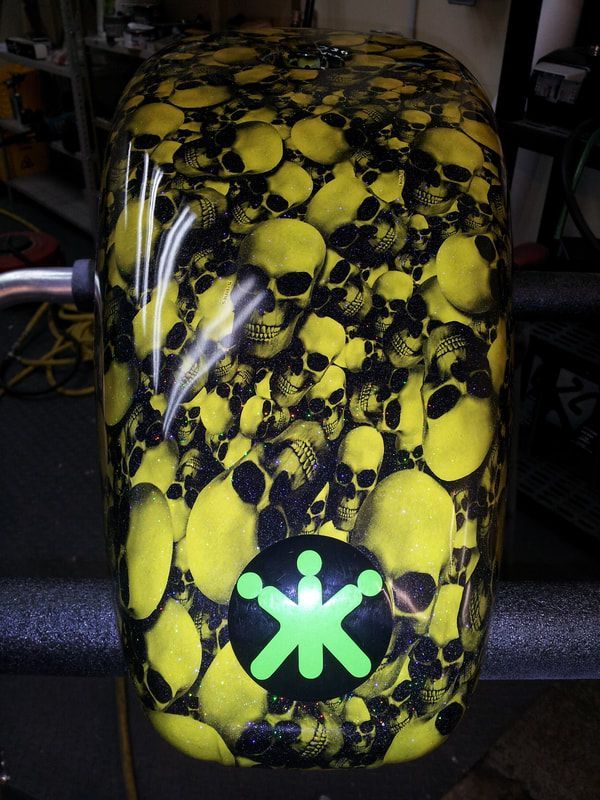 A yellow and black skull design with a green star in the middle