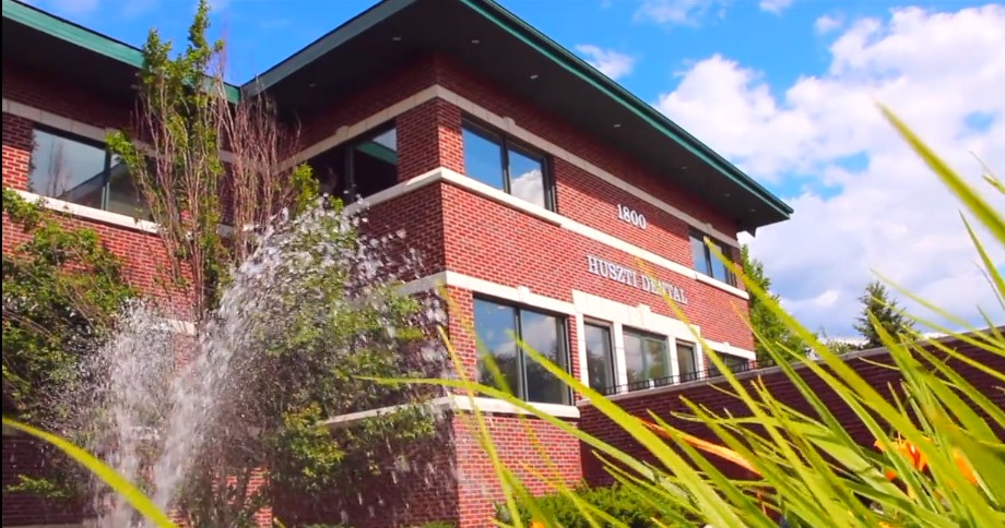 A brick building with a fountain in front of it