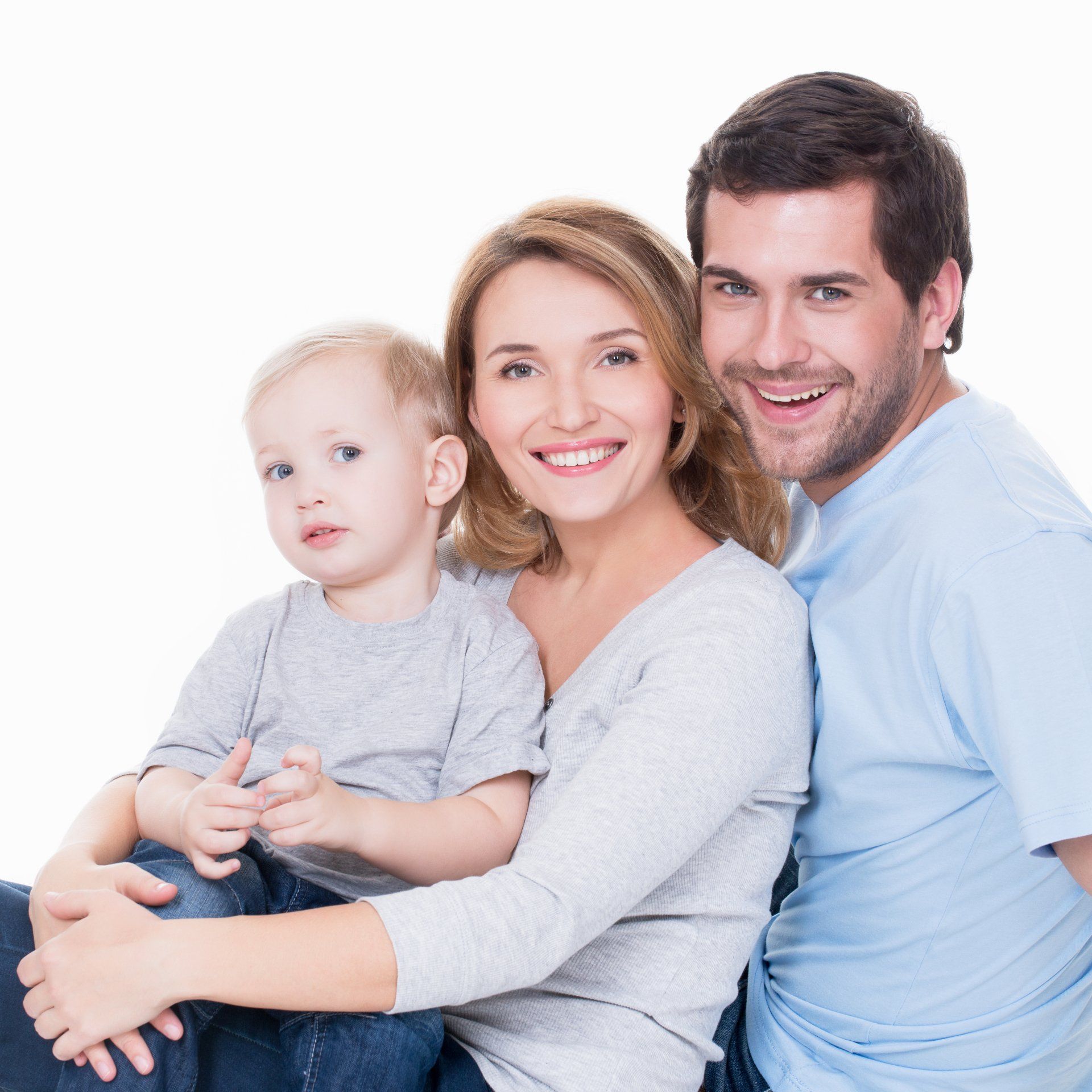 A family is posing for a picture while sitting on the floor.