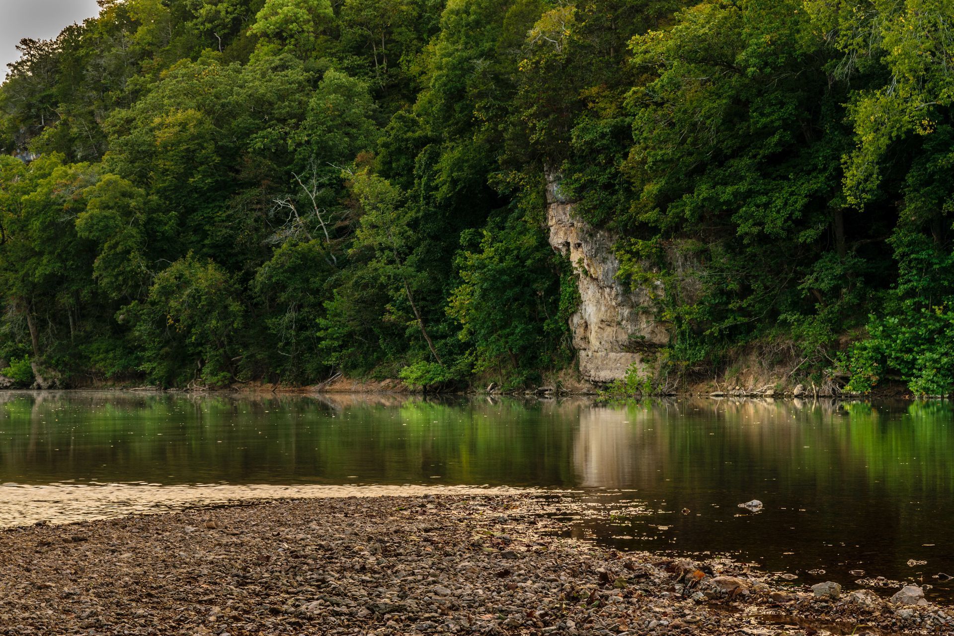 A large body of water surrounded by trees and rocks