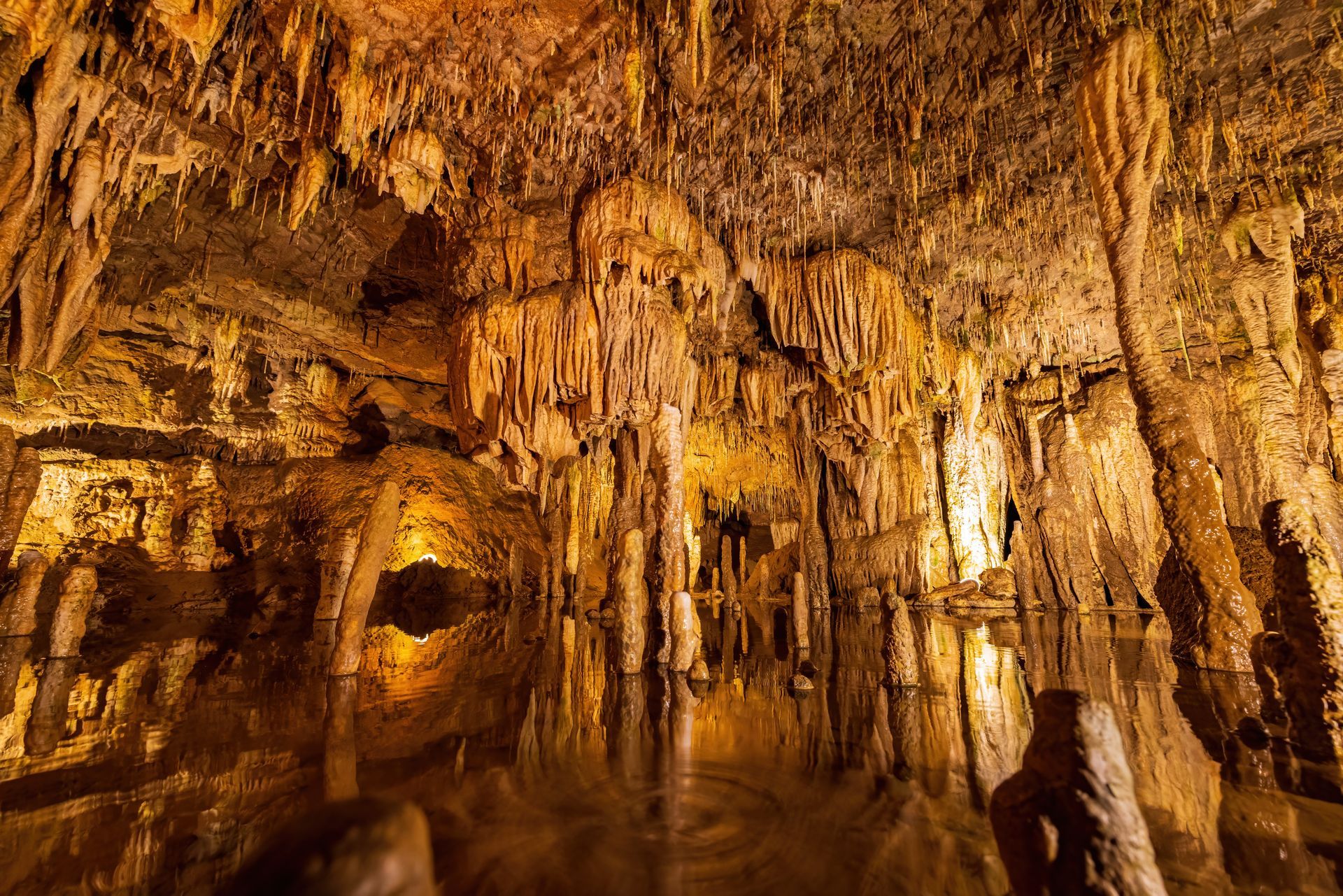 A cave filled with water and lots of rocks.