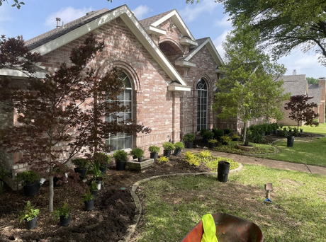 Stone house with arched front porch and curved walkway in a sunny yard