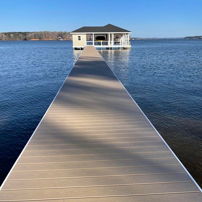 a dock leading to a small house in the middle of a lake