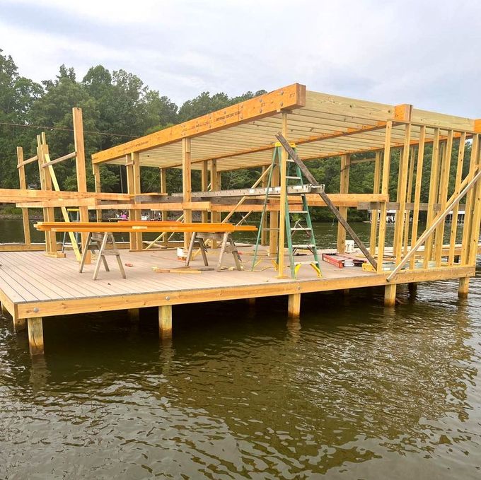 a wooden structure being built on top of a body of water