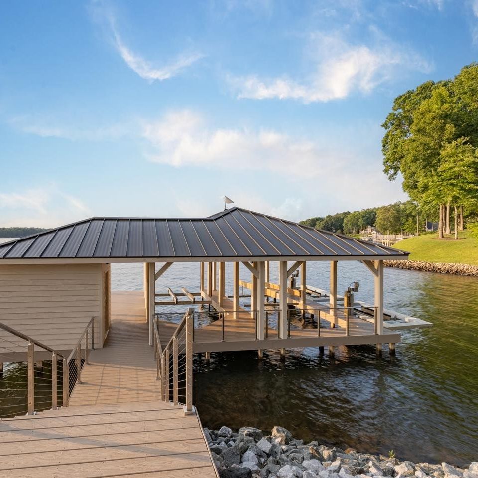a house is sitting on a dock next to a body of water