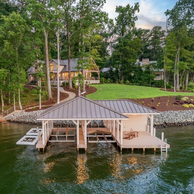 an aerial view of a dock with a house in the background