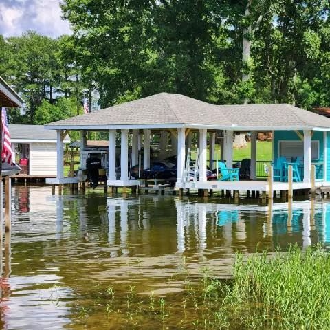 a lake with a boathouse in the background