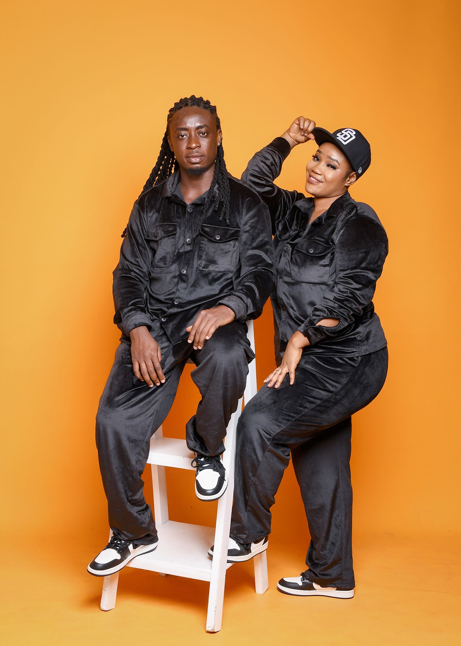 A man and a woman are sitting next to each other on a chair.