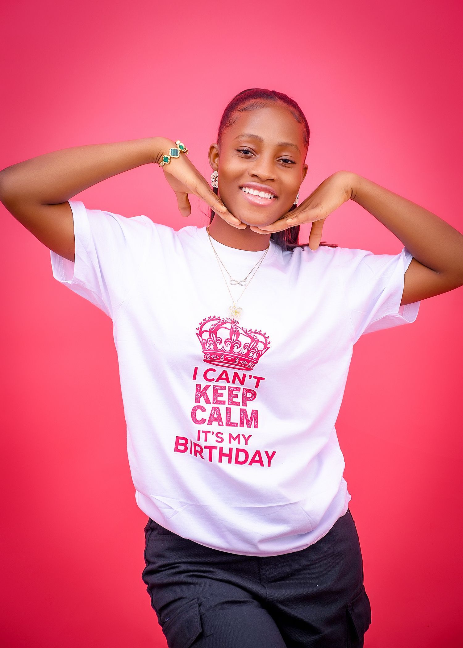 A woman is wearing a t-shirt that says `` i can t keep calm it 's my birthday ''.