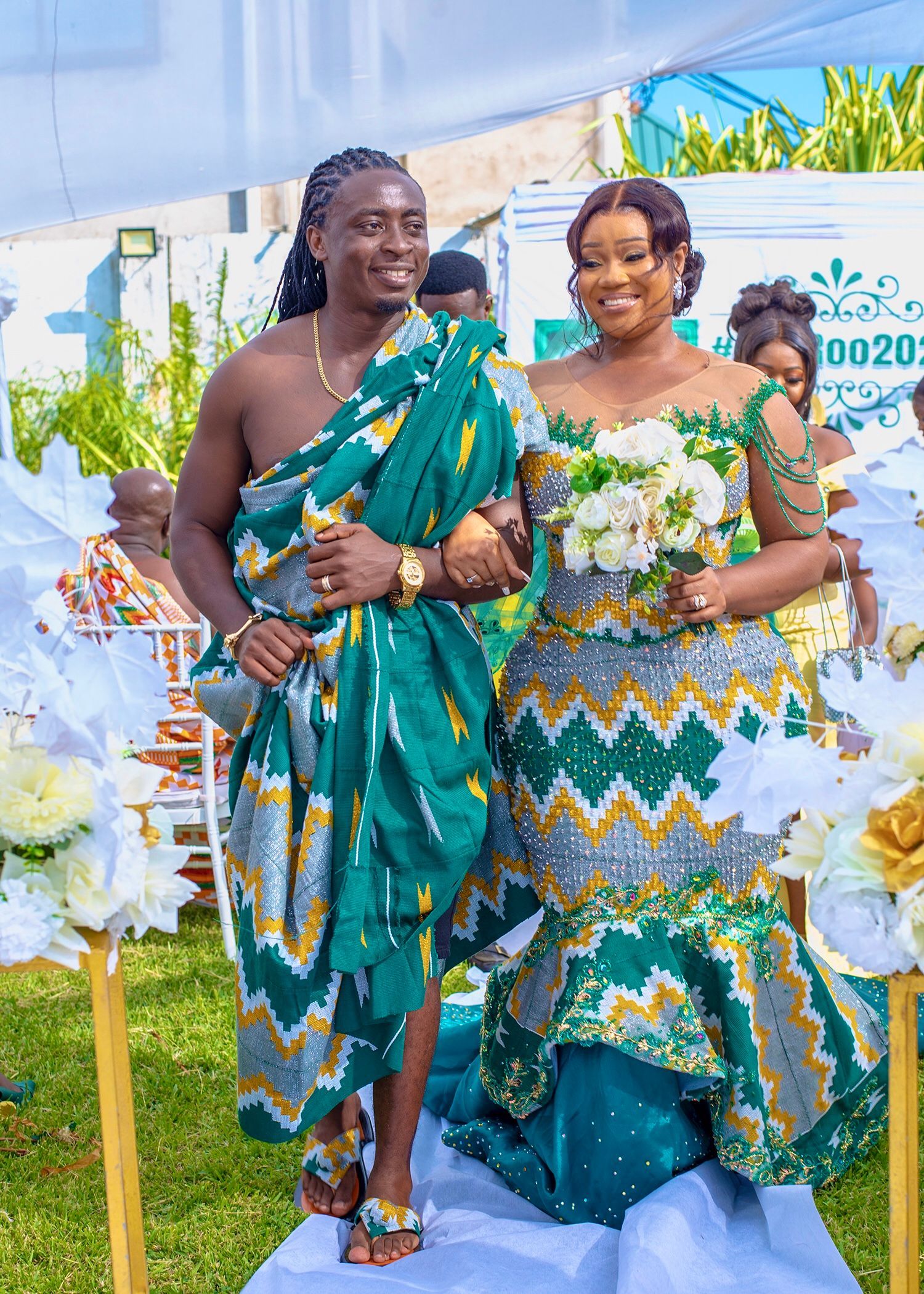 A bride and groom are walking down the aisle at their wedding.