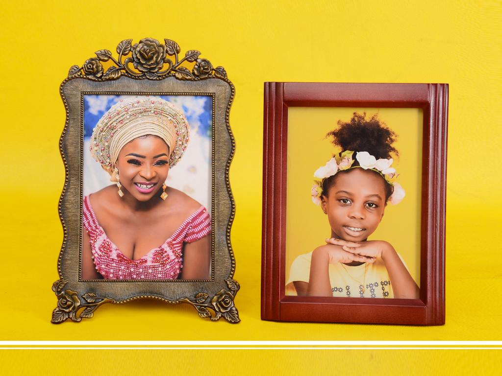 A picture of a woman and a picture of a girl are in frames on a yellow background.
