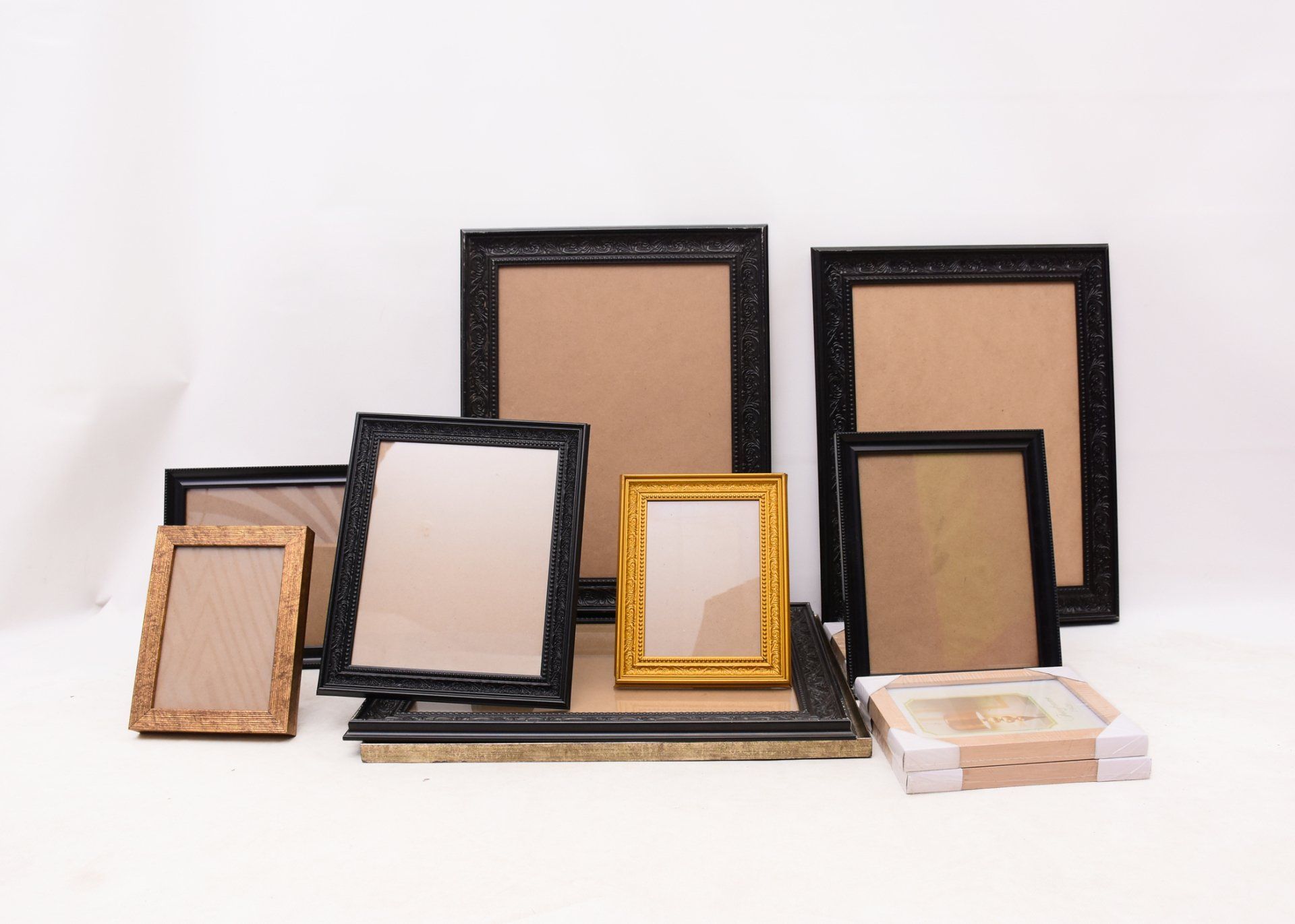 A group of picture frames of different sizes and shapes