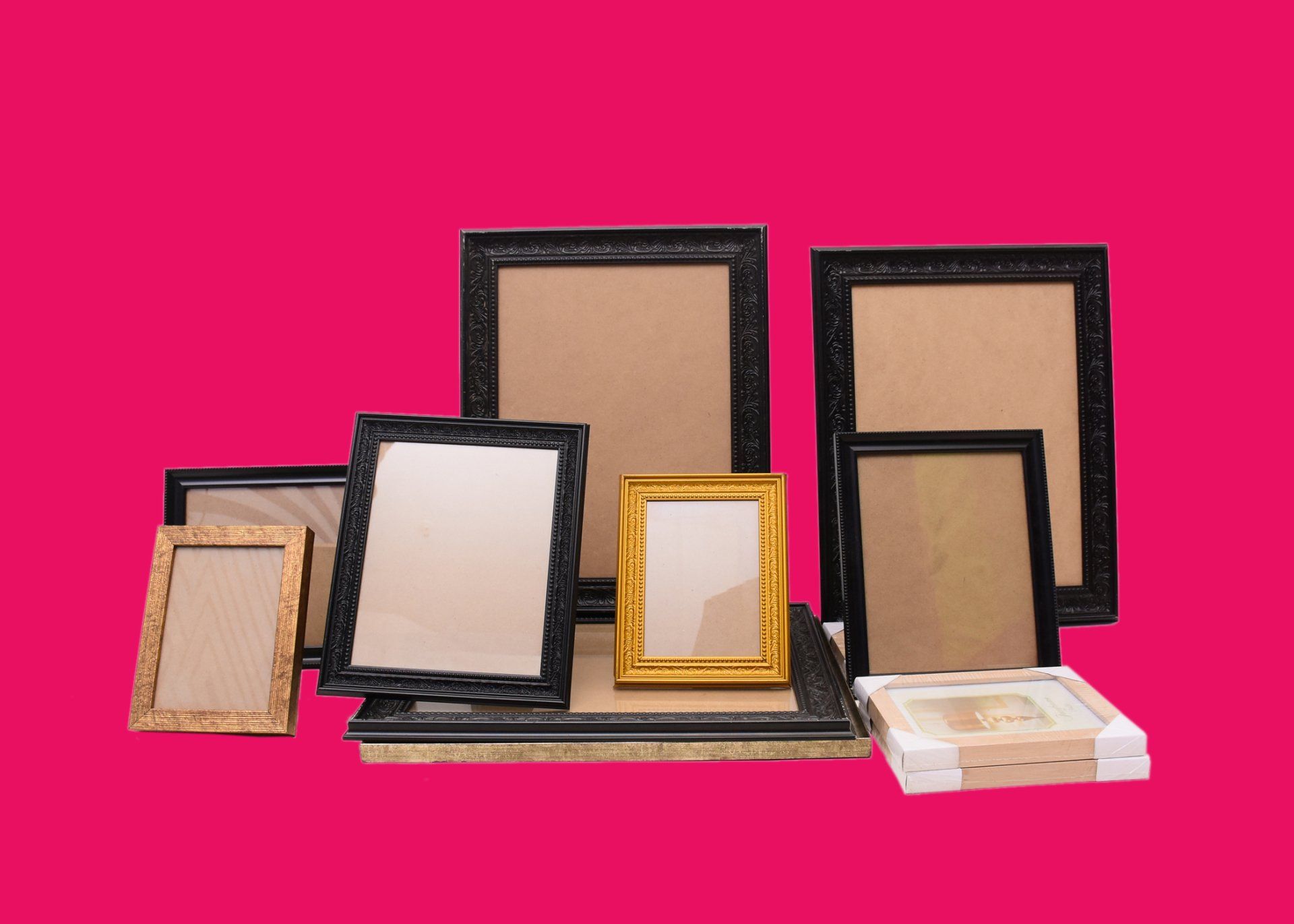 A group of picture frames are stacked on top of each other on a pink background.