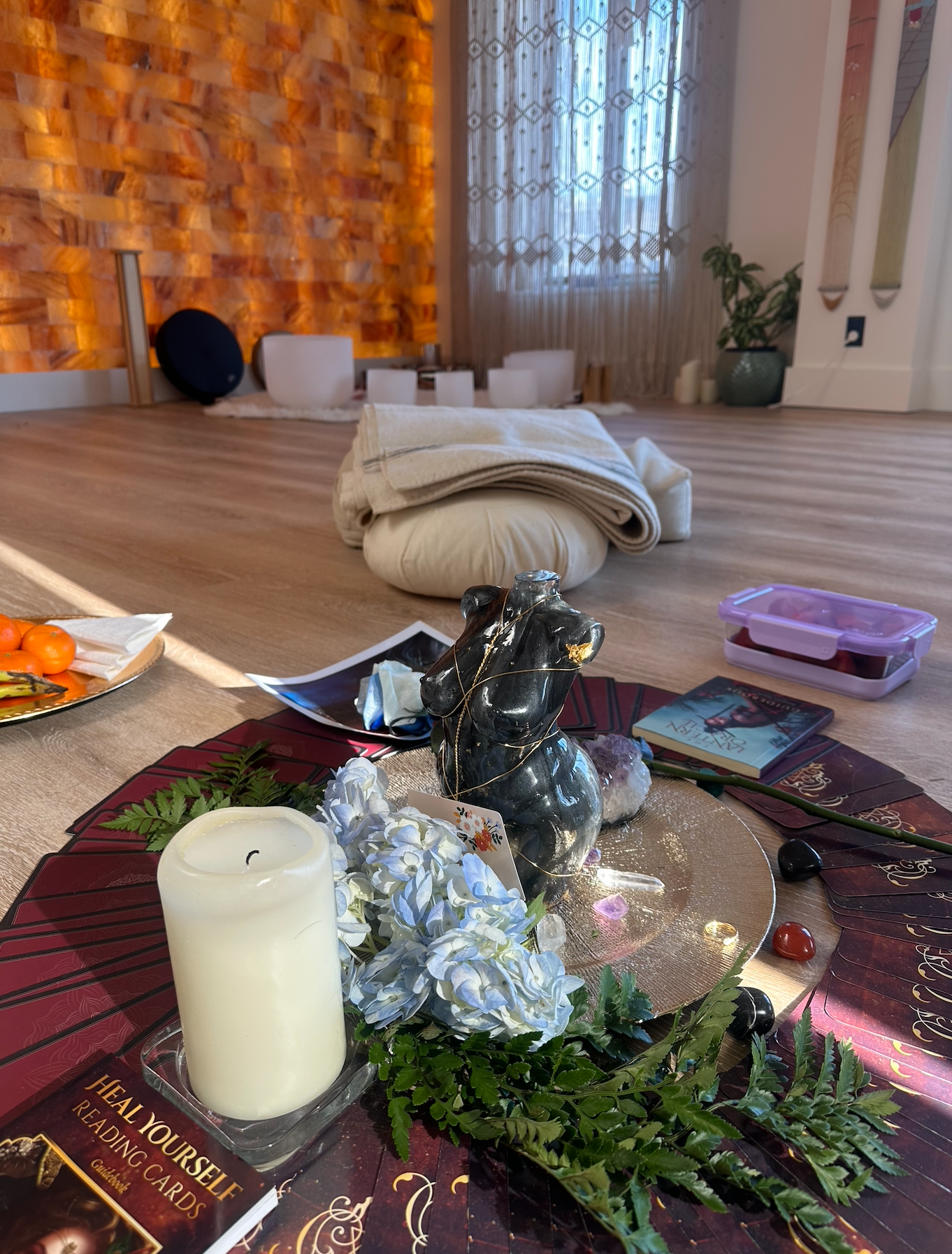 A calm wellness space with decorations, altar, and a salt wall.