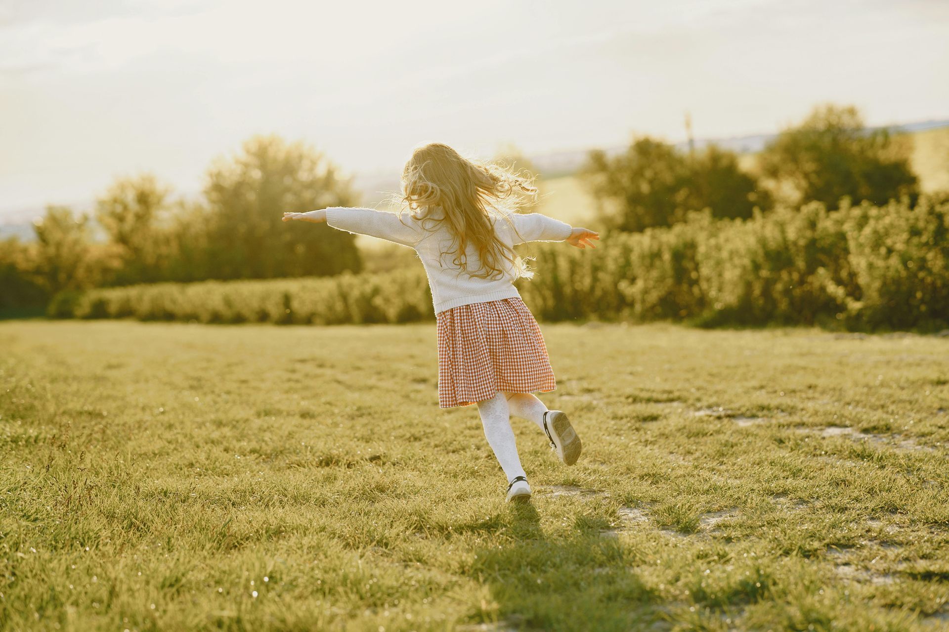 Young child running in field