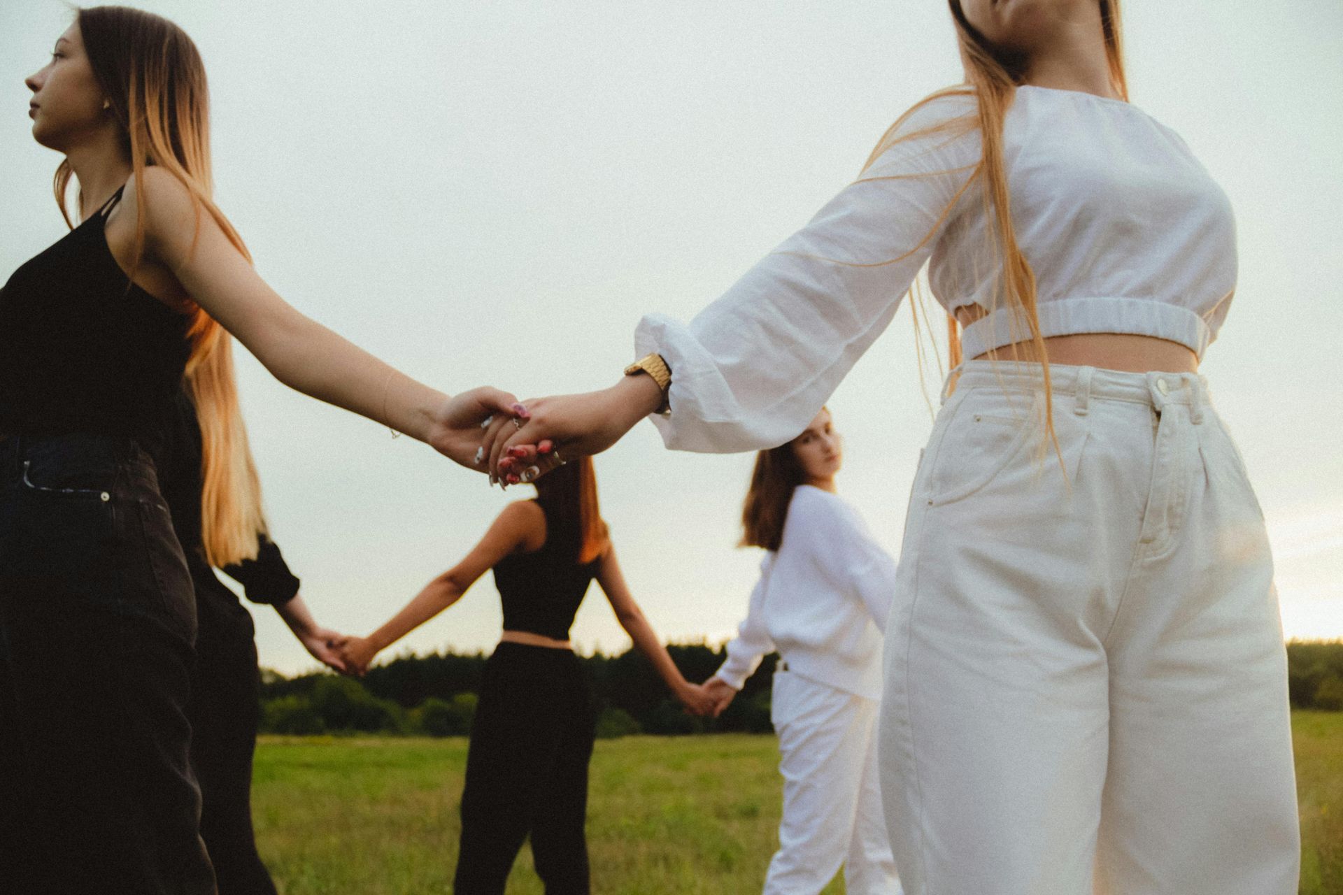 Women holding hands in a circle
