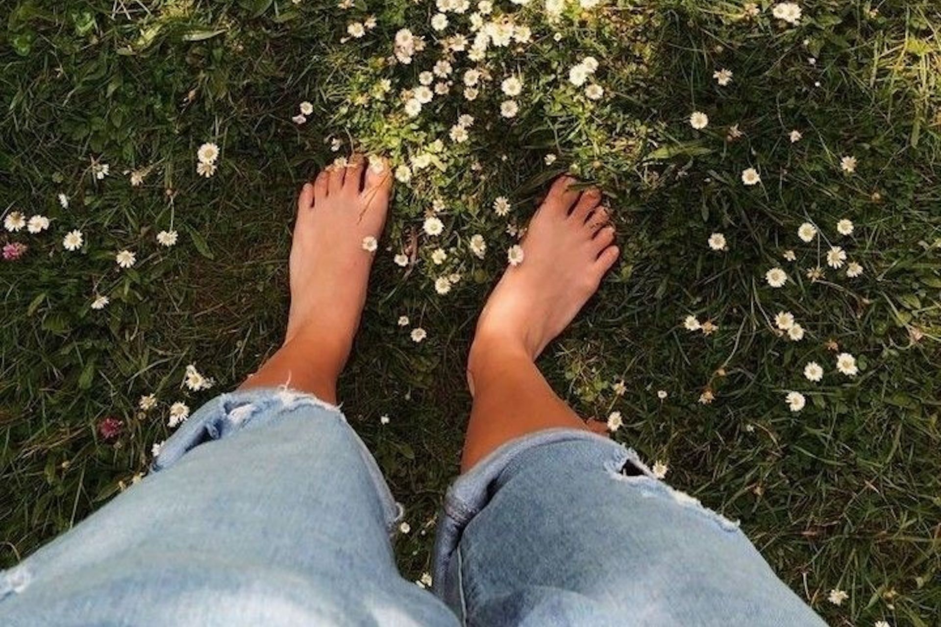 Woman grounding her bare feet on the grass
