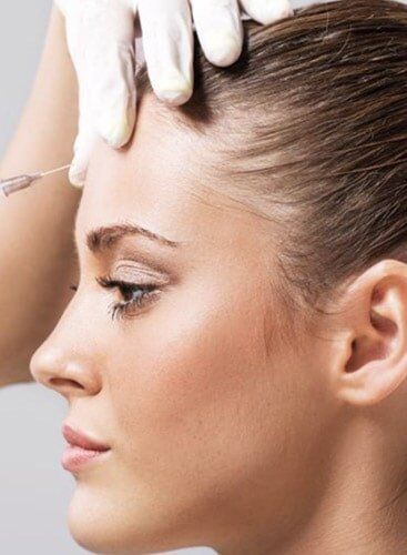 Botox — Doctor Inserting Botox Into Woman's Forehead in Franklin, TN