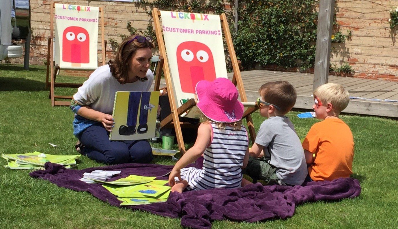 Tina Stubbs reading to children at an event