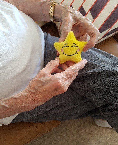 Elderly lady playing with a mood star