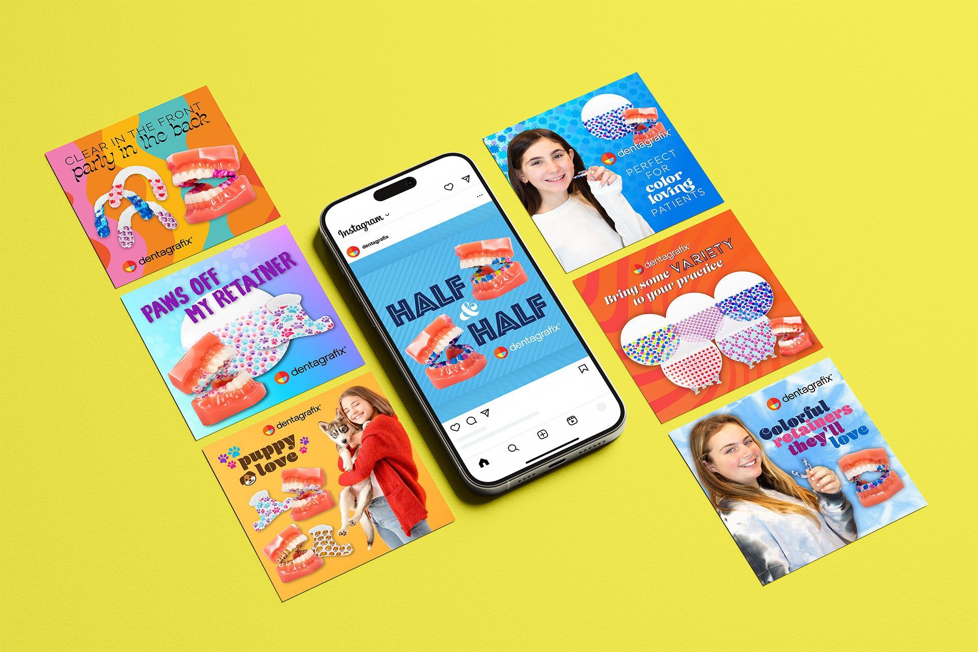 A cell phone is sitting on top of a yellow table next to a bunch of cards.