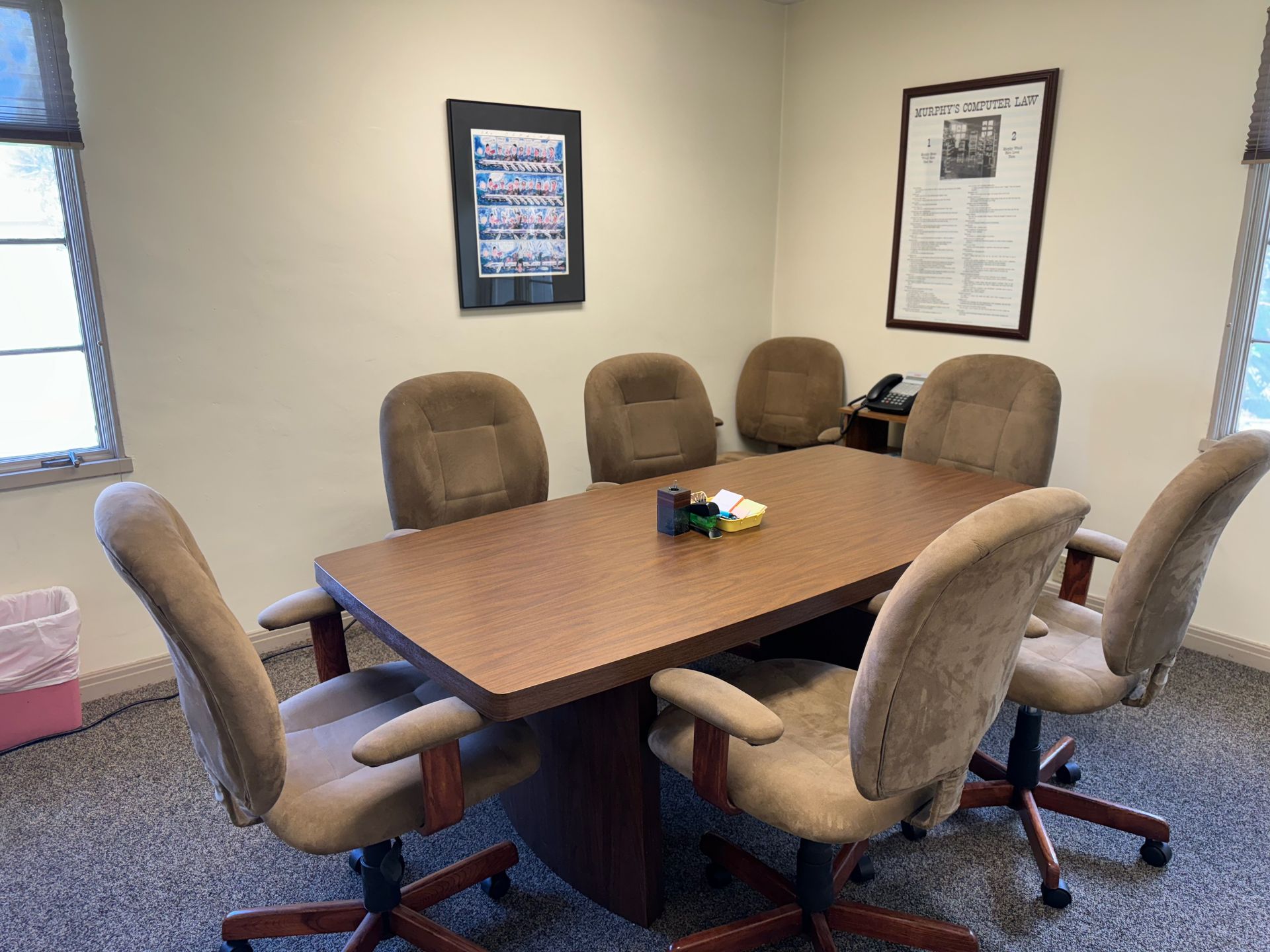 A conference room with a long table and chairs