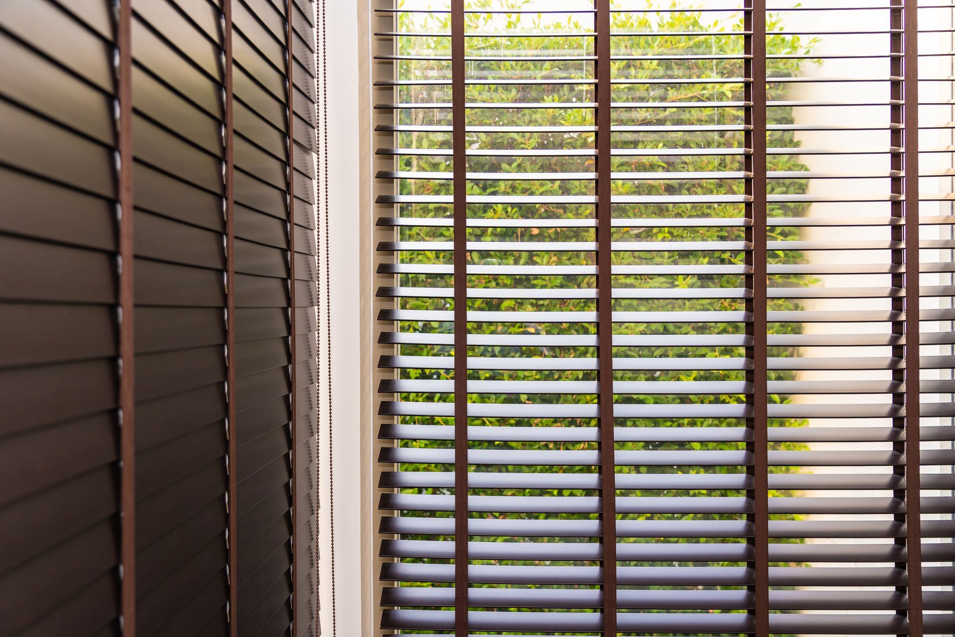 Dark wooden blinds over a window.