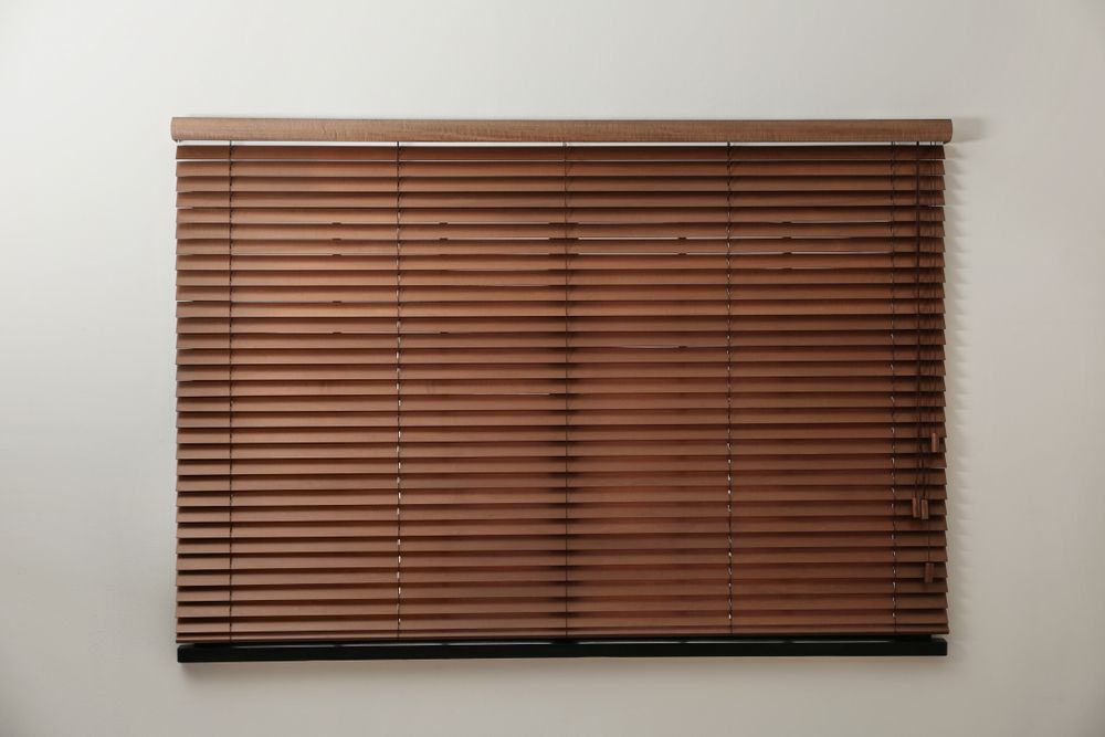Dark wooden blinds over a window.