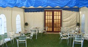 Silver tables and chairs in a marquee