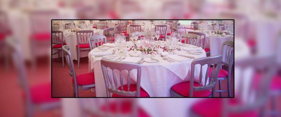 Wedding breakfast with silver chairs and pink cushions