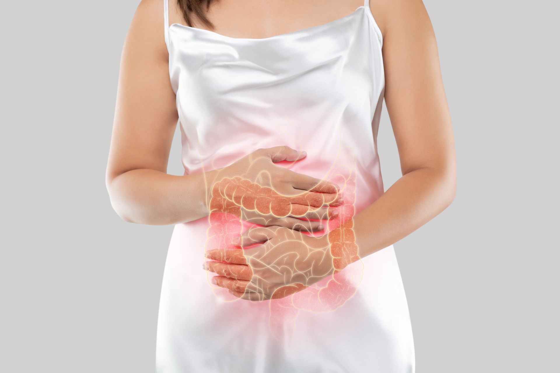 a woman in a white dress is holding her stomach in pain