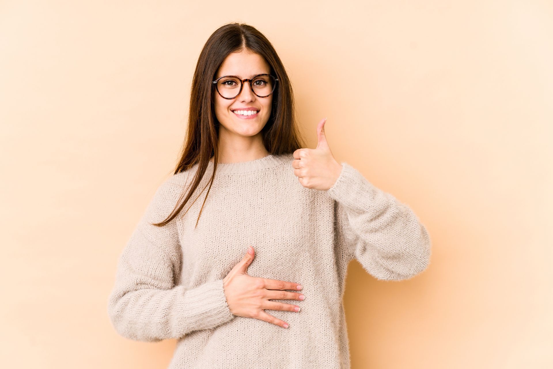 a woman wearing glasses is giving a thumbs up