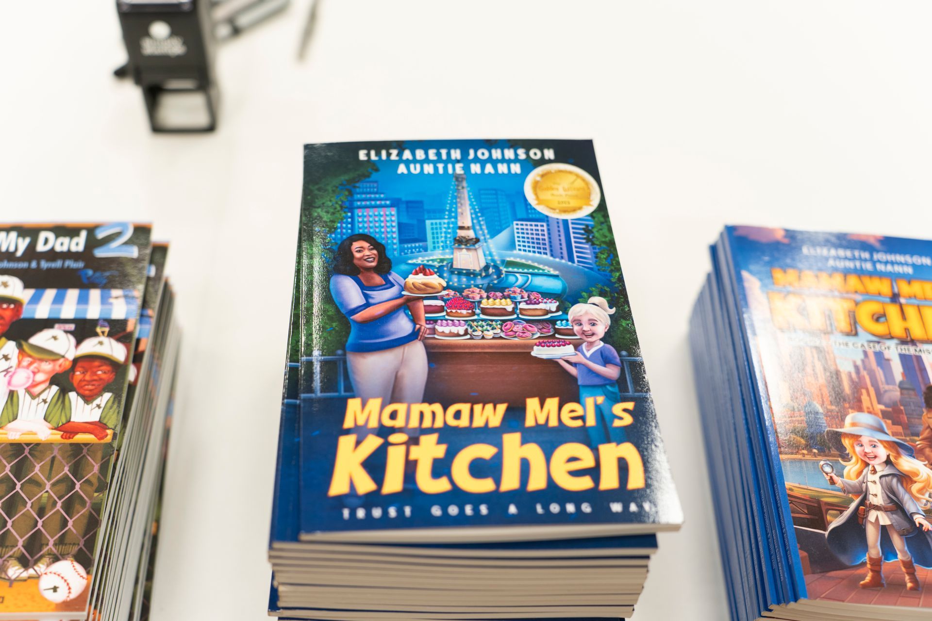 A stack of mamaw mei 's kitchen books on a table
