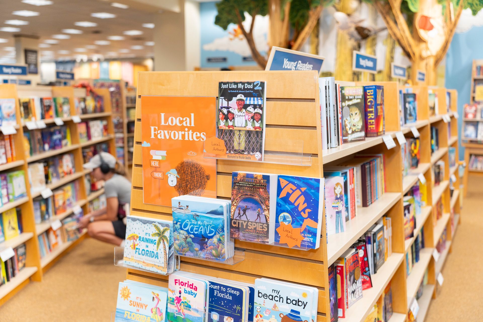 A man is looking at books in a bookstore.