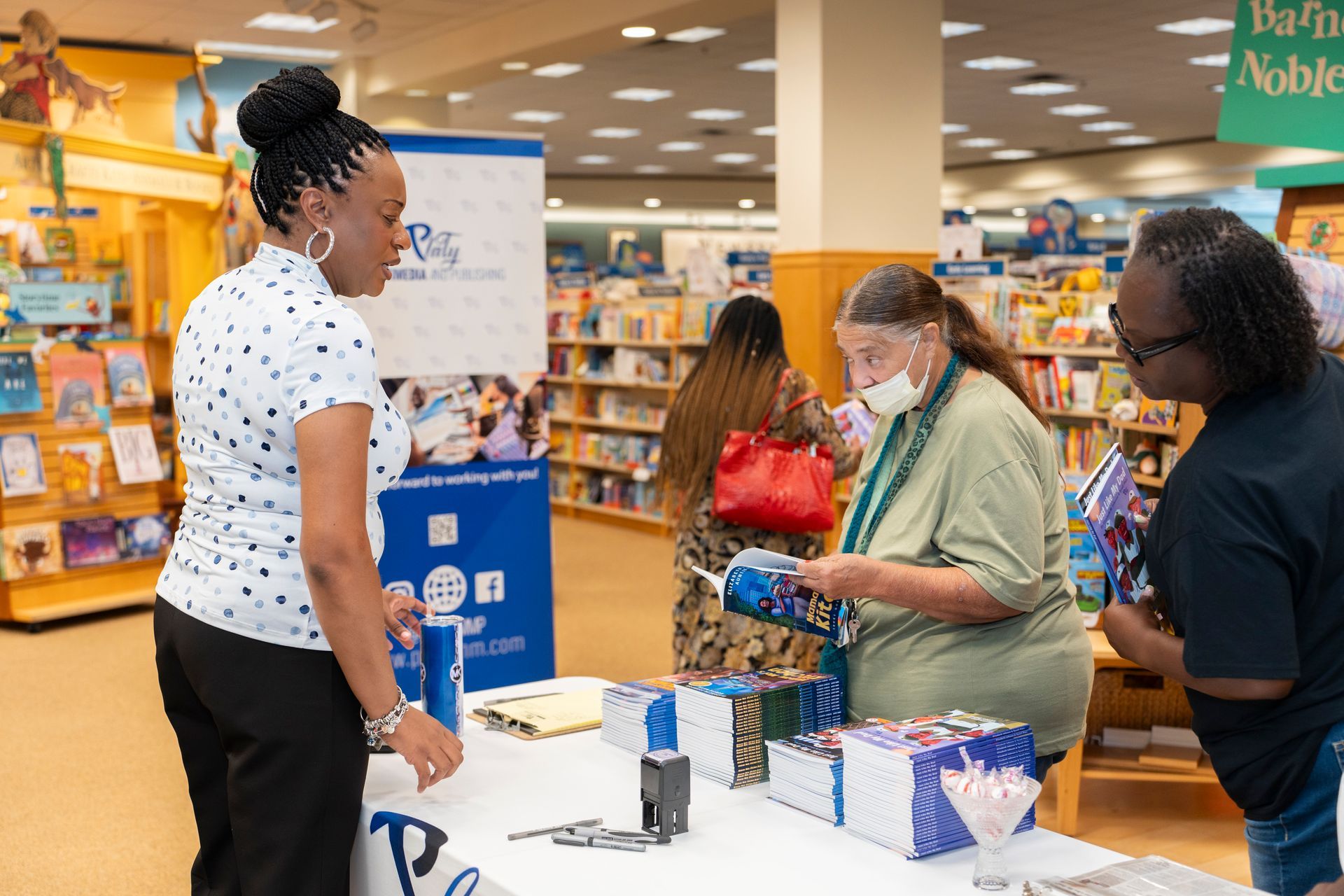 A group of people are standing around a table in a bookstore.