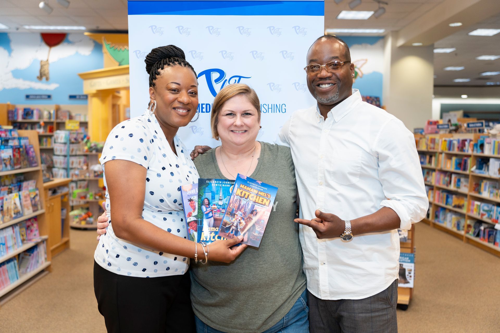A group of people are posing for a picture in a bookstore.