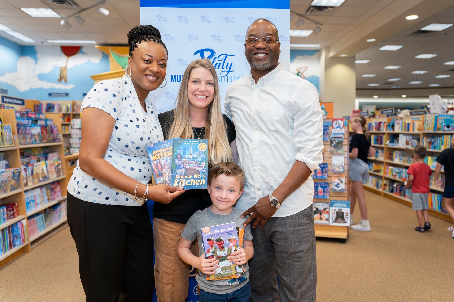 A group of people are posing for a picture in a bookstore.