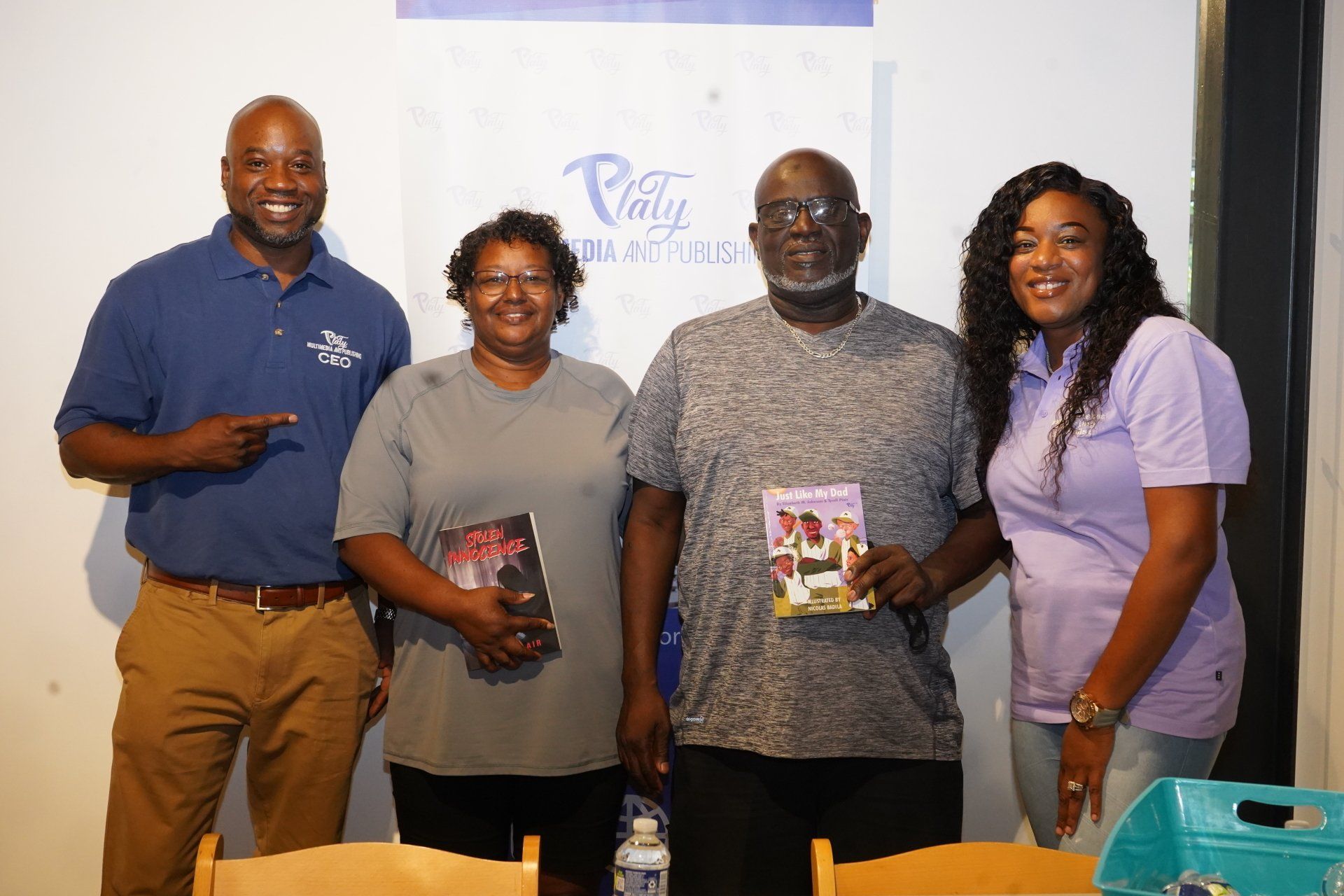 A group of people standing next to each other holding books.