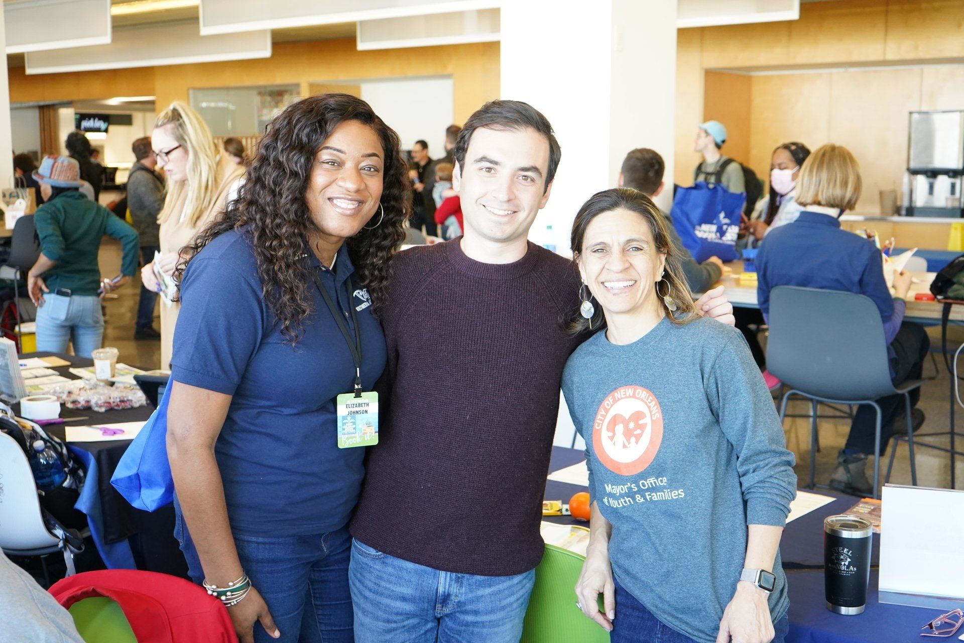 A group of people are posing for a picture in a room.