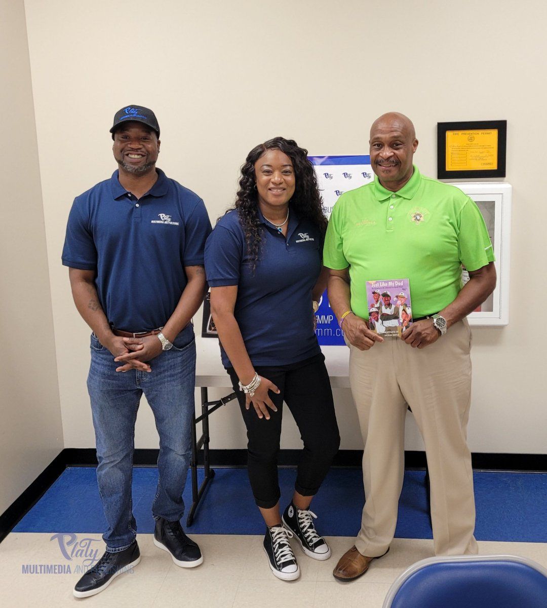 Three people are posing for a picture in a room.