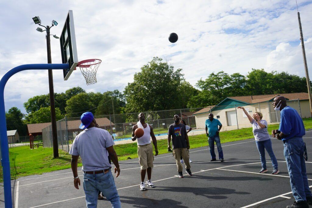 A group of people are playing basketball on a court