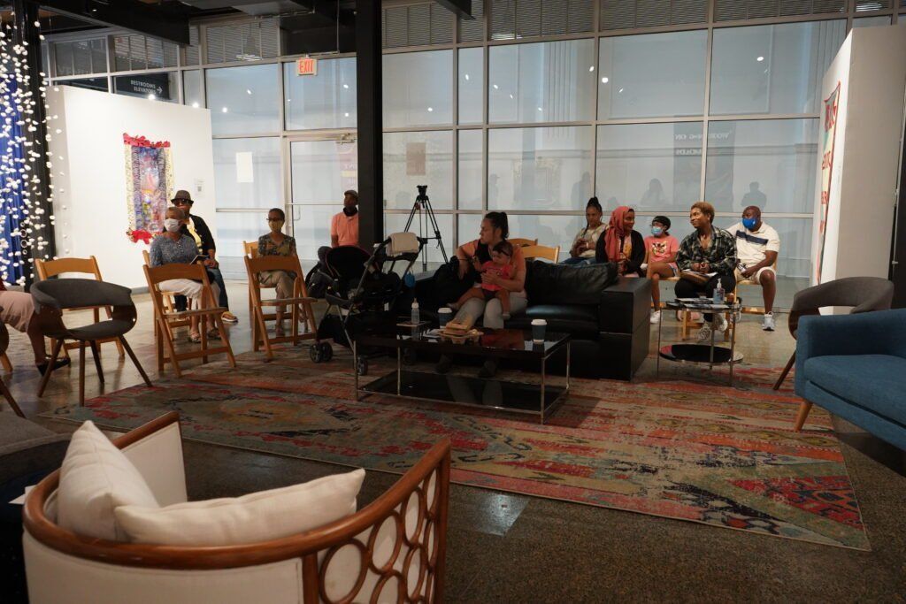 A group of people are sitting in a living room.