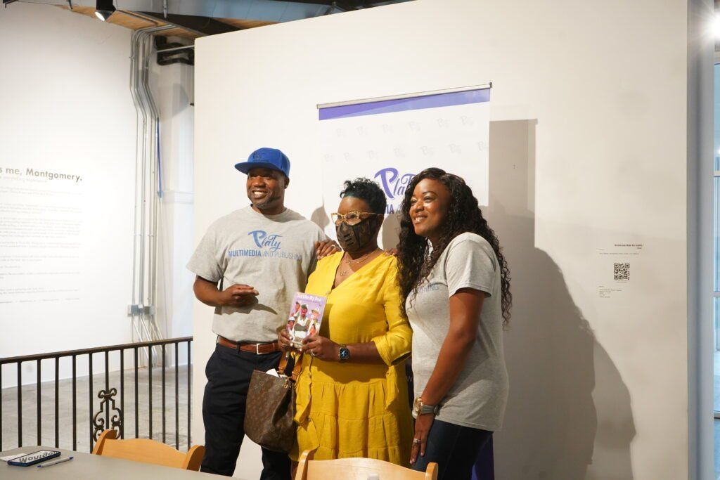 A group of people standing next to each other in a room.