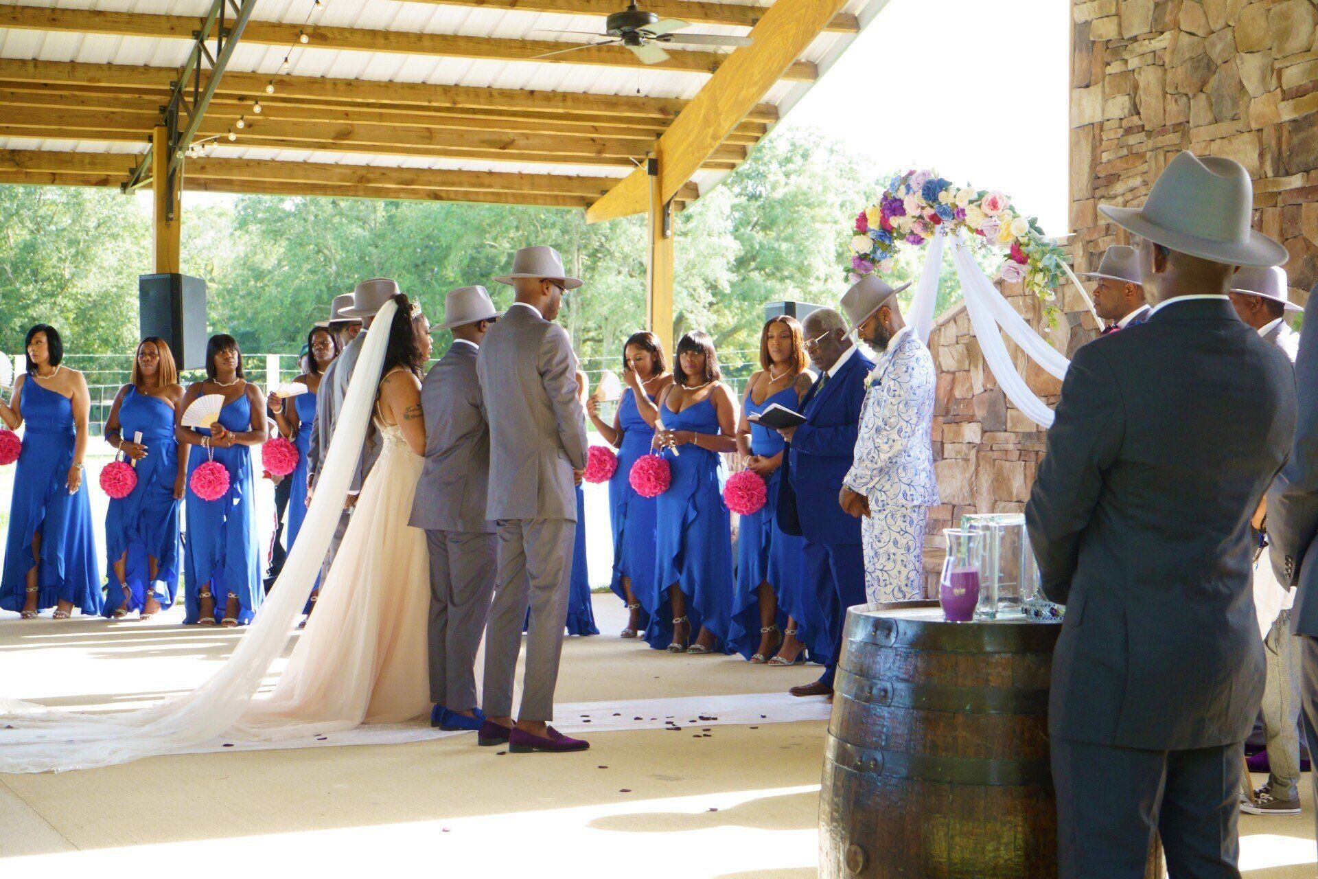 A bride and groom are getting married in front of their wedding party.