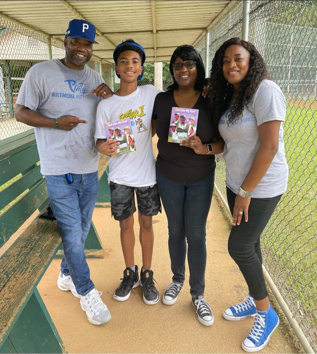 A group of people standing next to each other on a baseball field