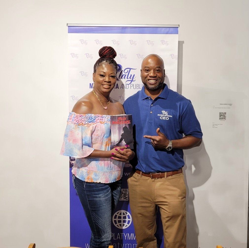 A man and a woman are posing for a picture in front of a banner.