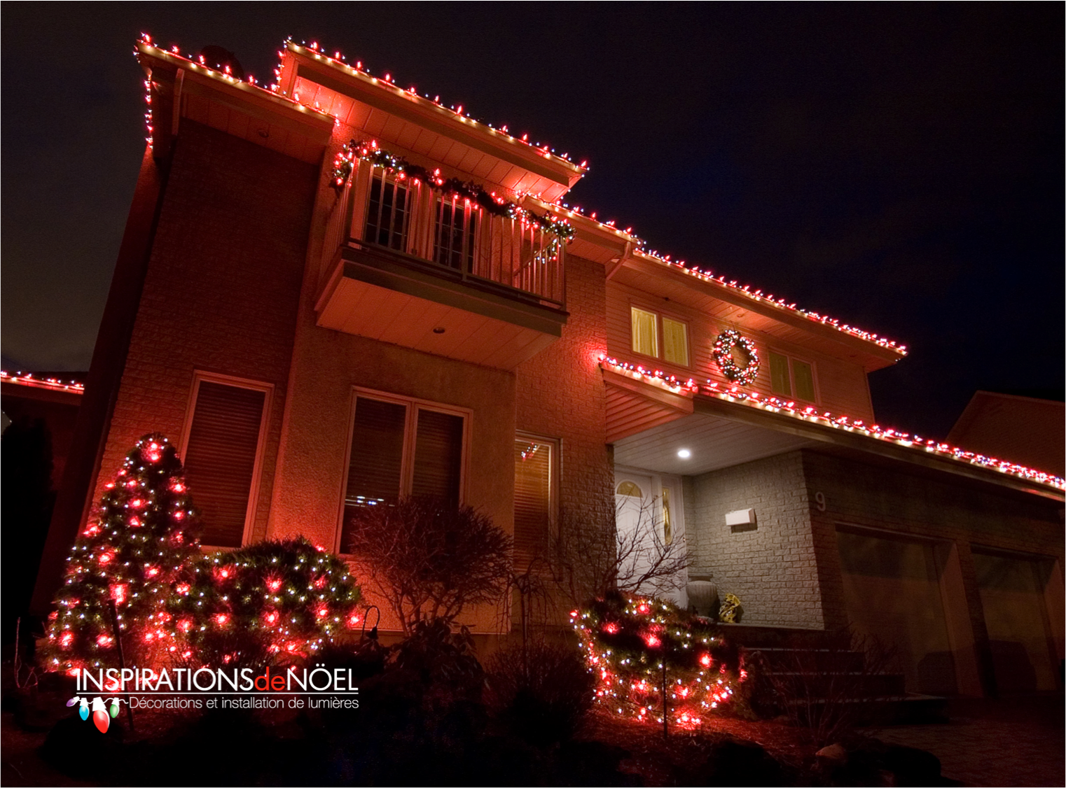 A house is decorated with red and white christmas lights